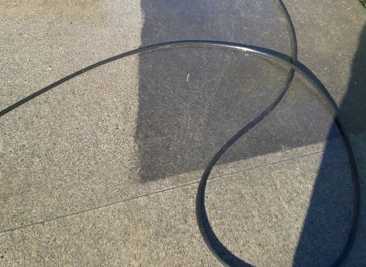 Before and after photo of a cobblestone driveway that has been cleaned